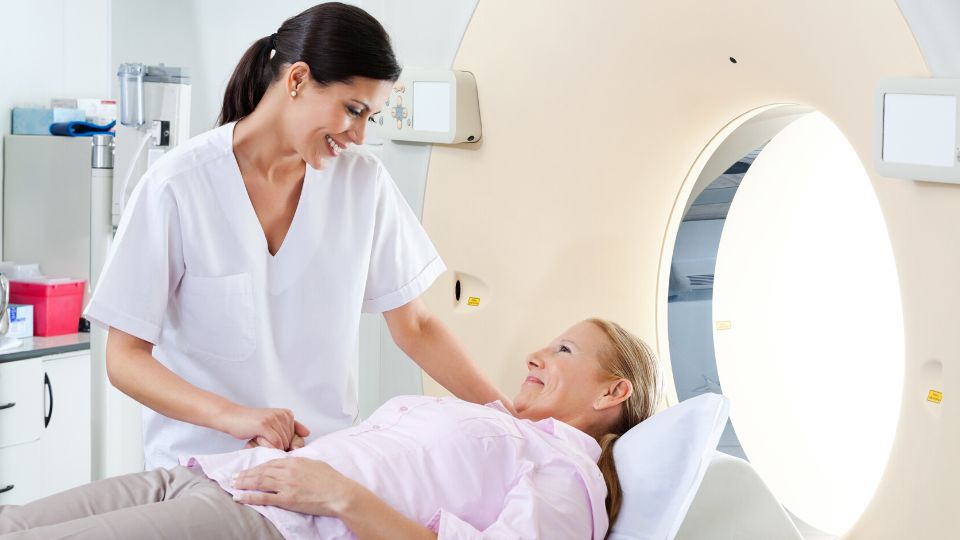 ct scan in orange county, ct scan benefits, benefits of a ct scan image of ct scan patient lying on CT scanner table, advantages of ct scan